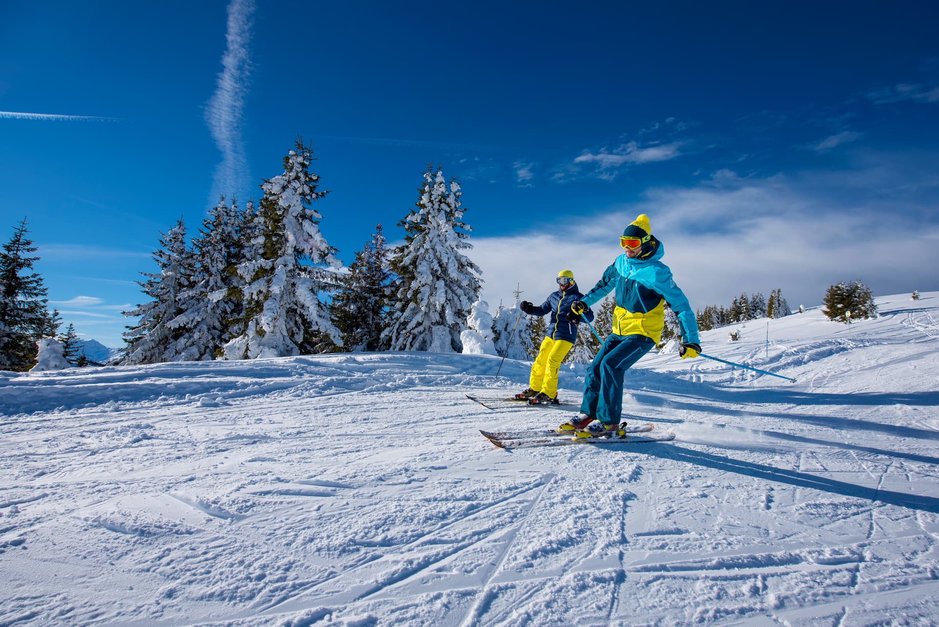 Skiers enjoying blue ski slope